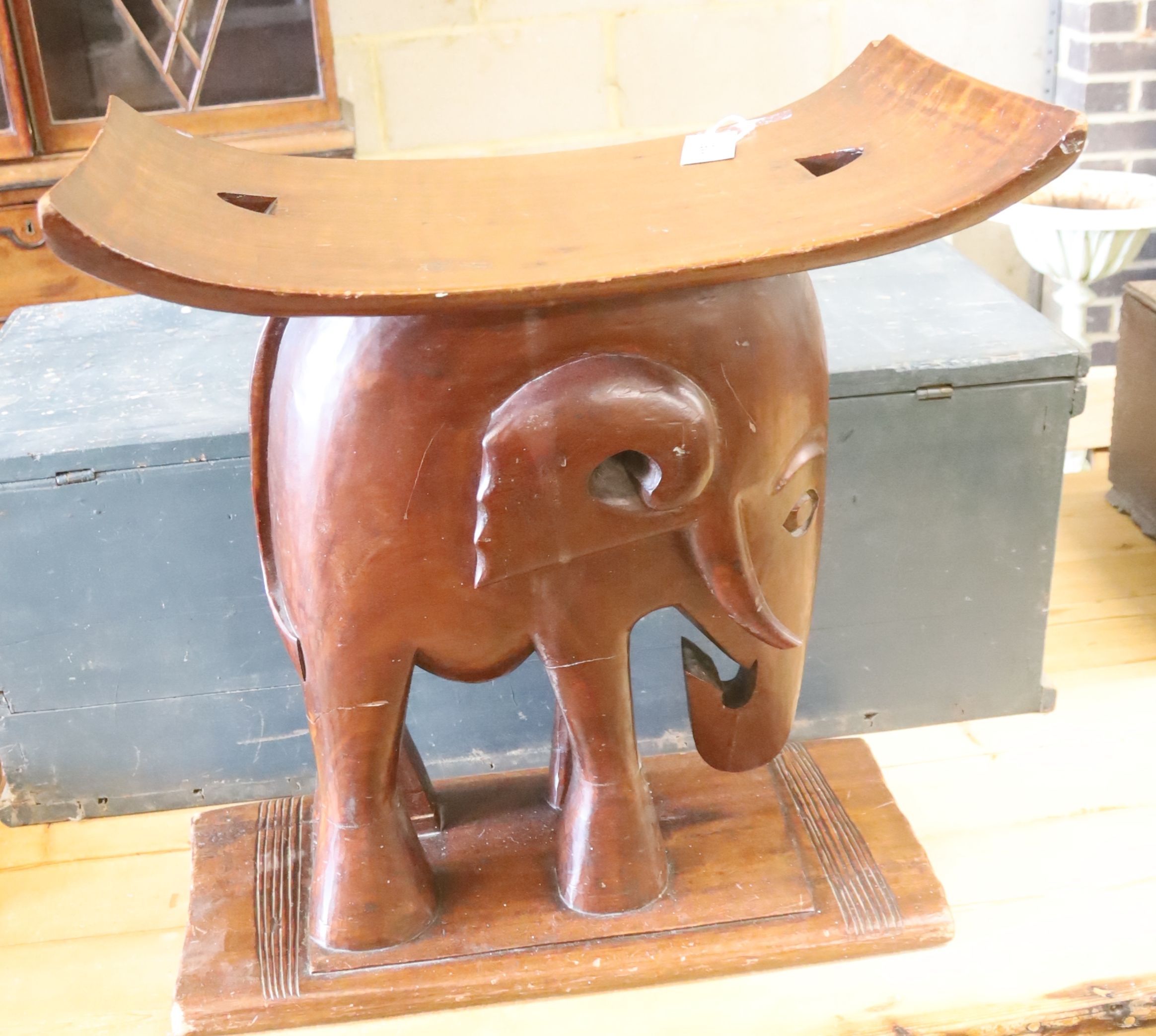 An Ashanti carved elephant stool, width 55cm, depth 26cm, height 58cm